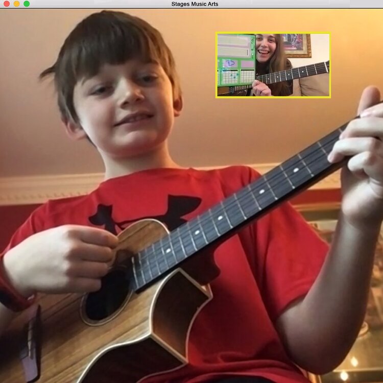 Boy plays guitar during a virtual lesson