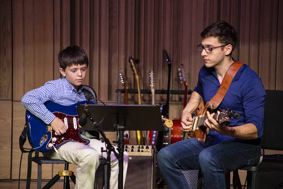 A Stages' student performs with his instructor.